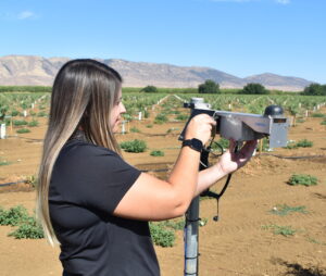 Grow West PCA Rachael Wilson checking a soil moisture probe. 