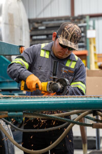 Grow West Trucking shop technician Jose Cuellar is one of many employees covered by the benefits of captive insurance.