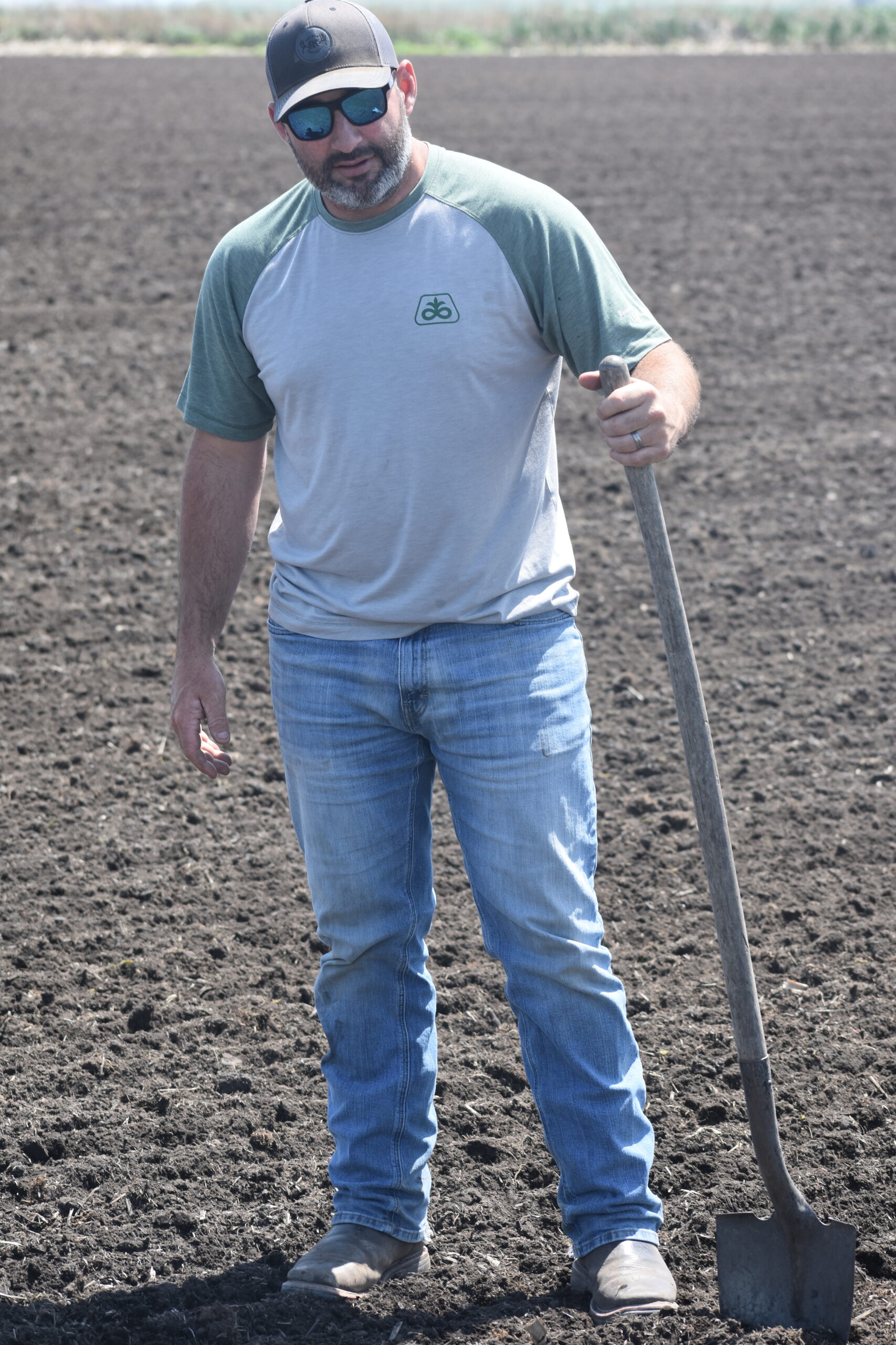 Conservation Farms & Ranches Director and President Jerred Dixon showing freshly drilled seed.